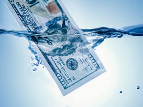 A $100 bill floating in water, signifying how much money is wasted on water